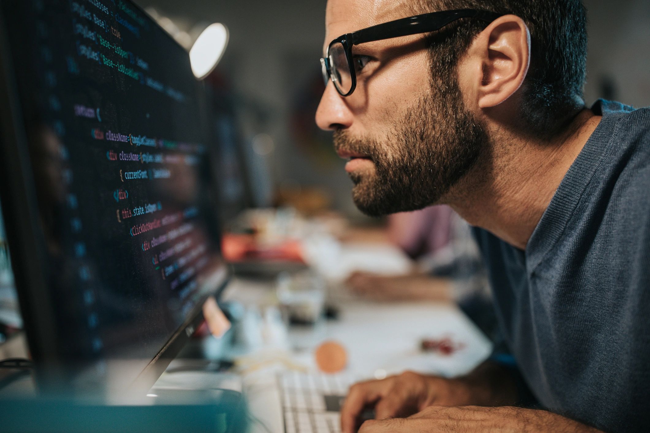 IT professional working on a desktop computer in an office