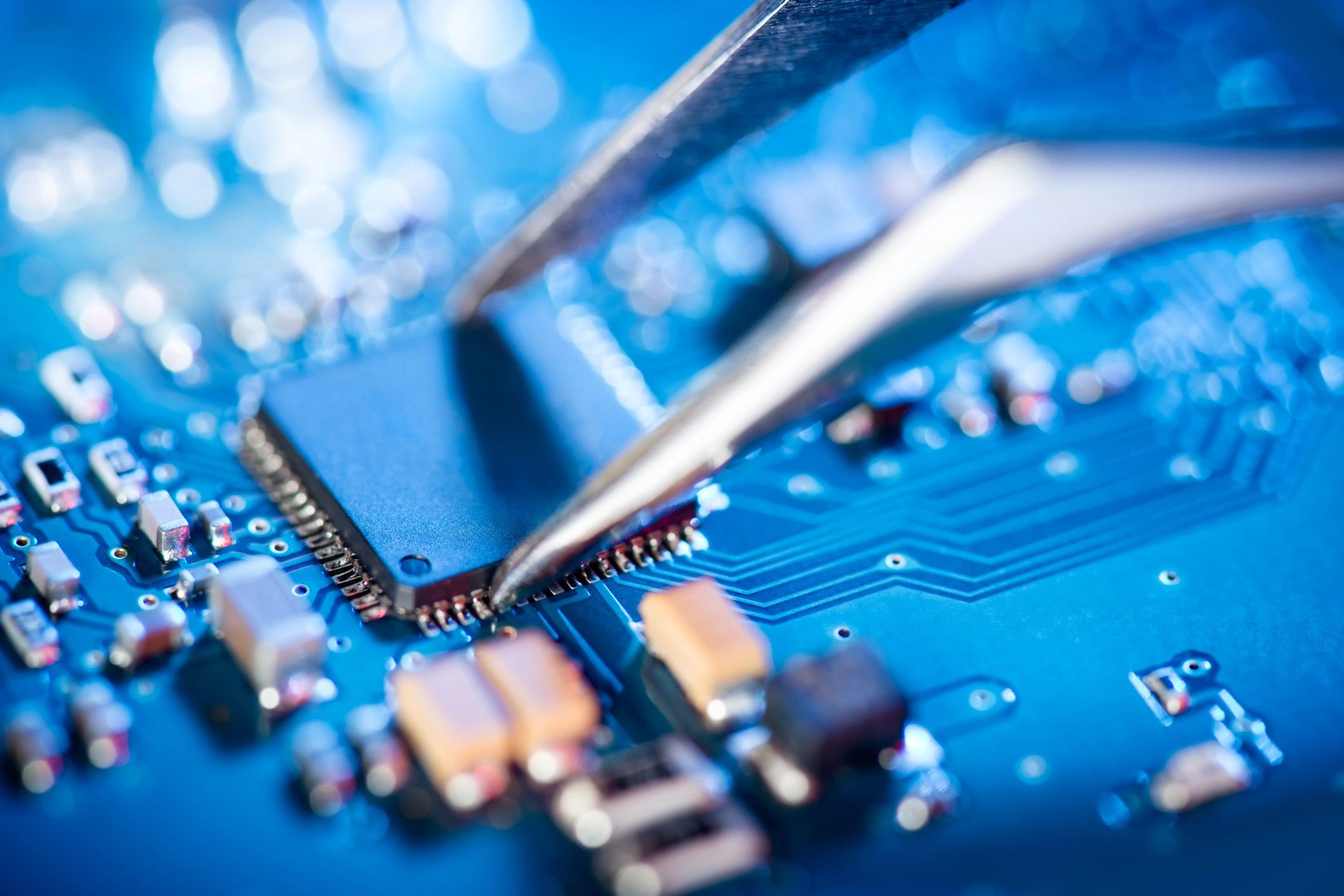 Technician working on a circuit board representing hardware repair