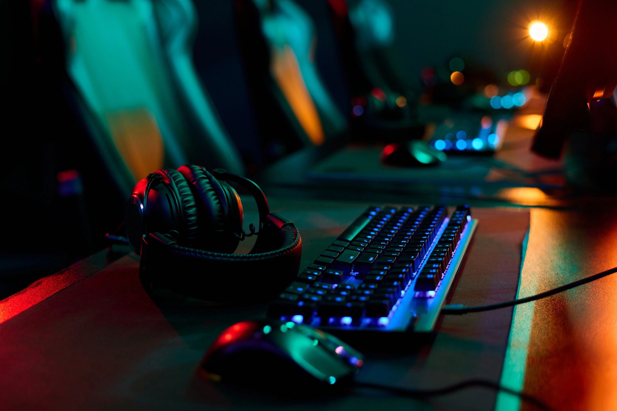Computer peripherals on a desk including keyboard and headset