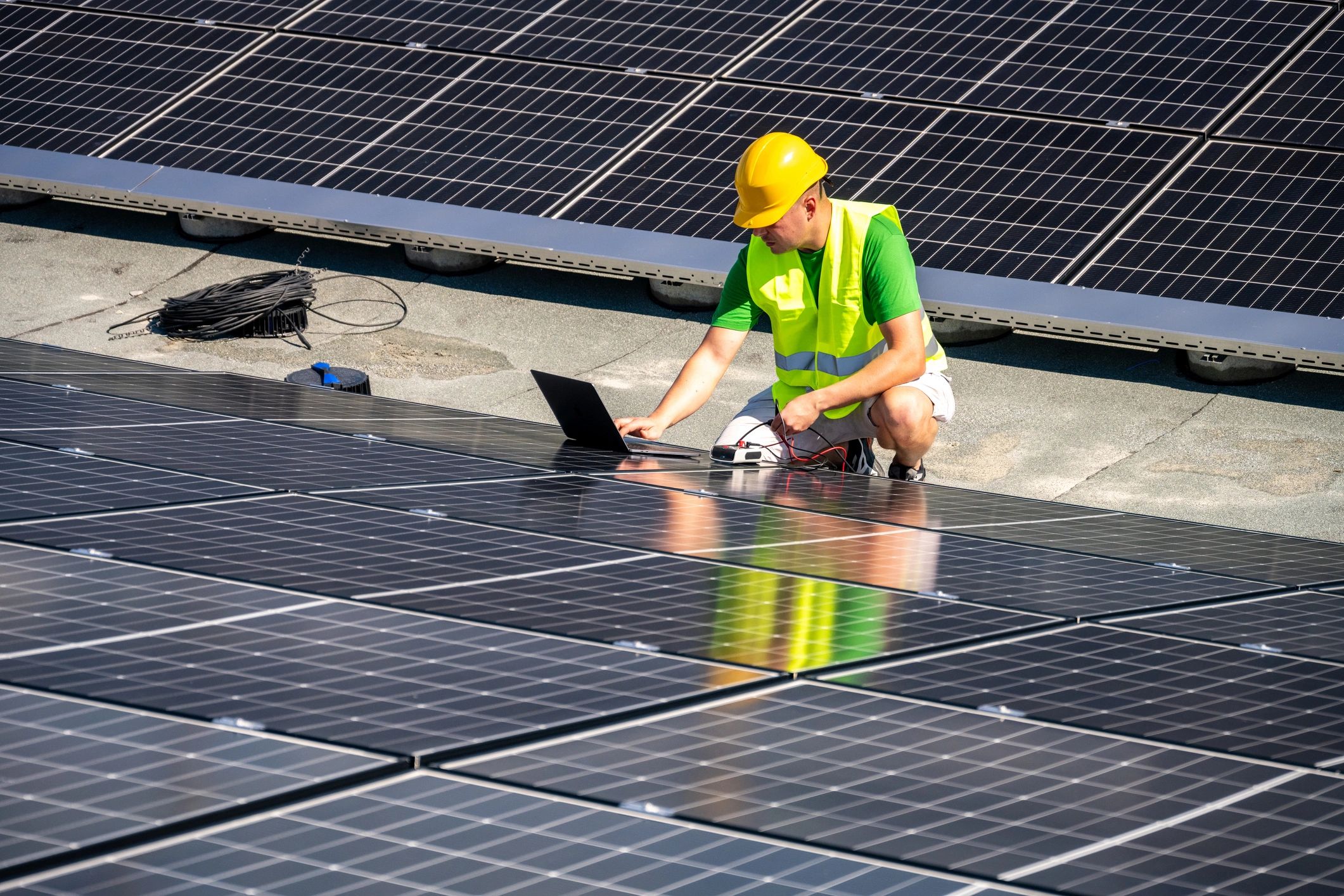Technician using a laptop to diagnose equipment on-site